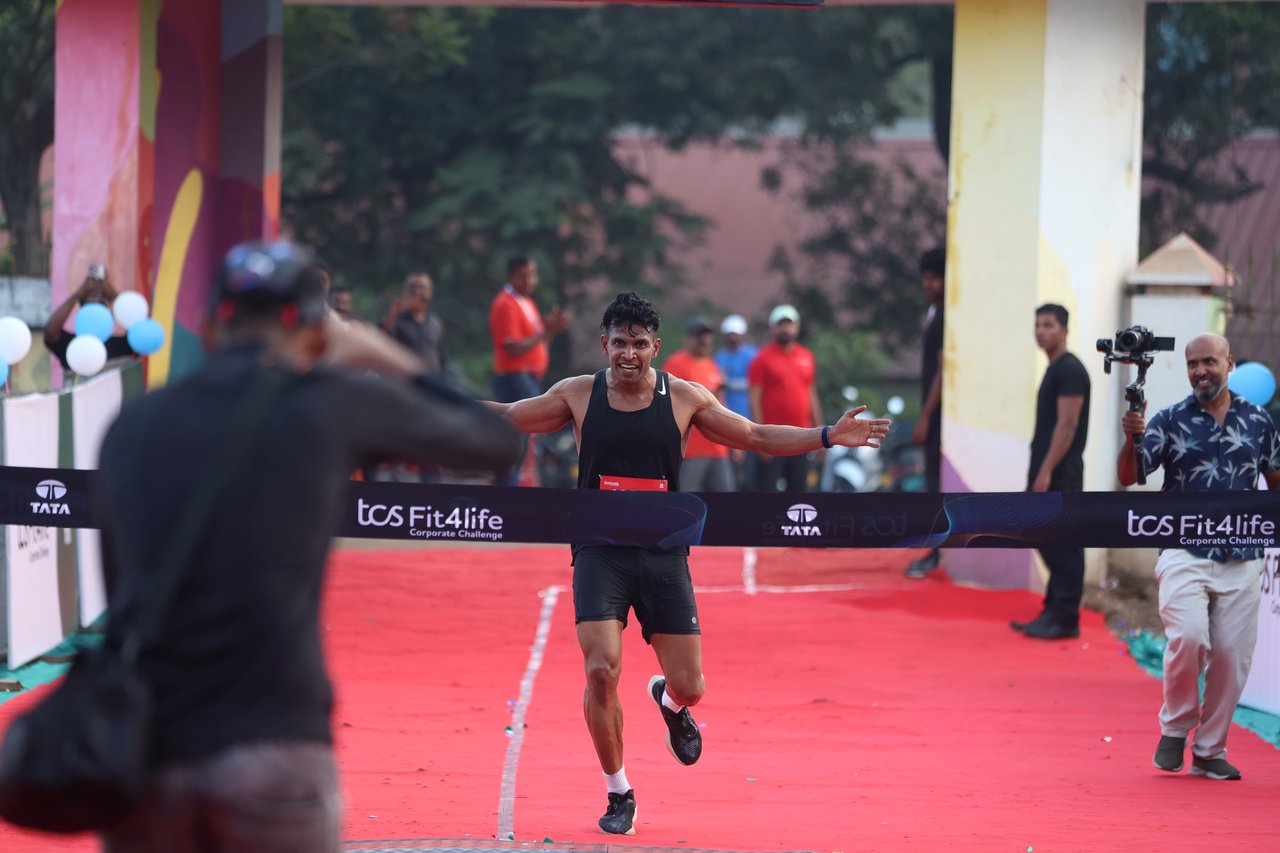 Coach Joby winning the race, breaking the finish tape