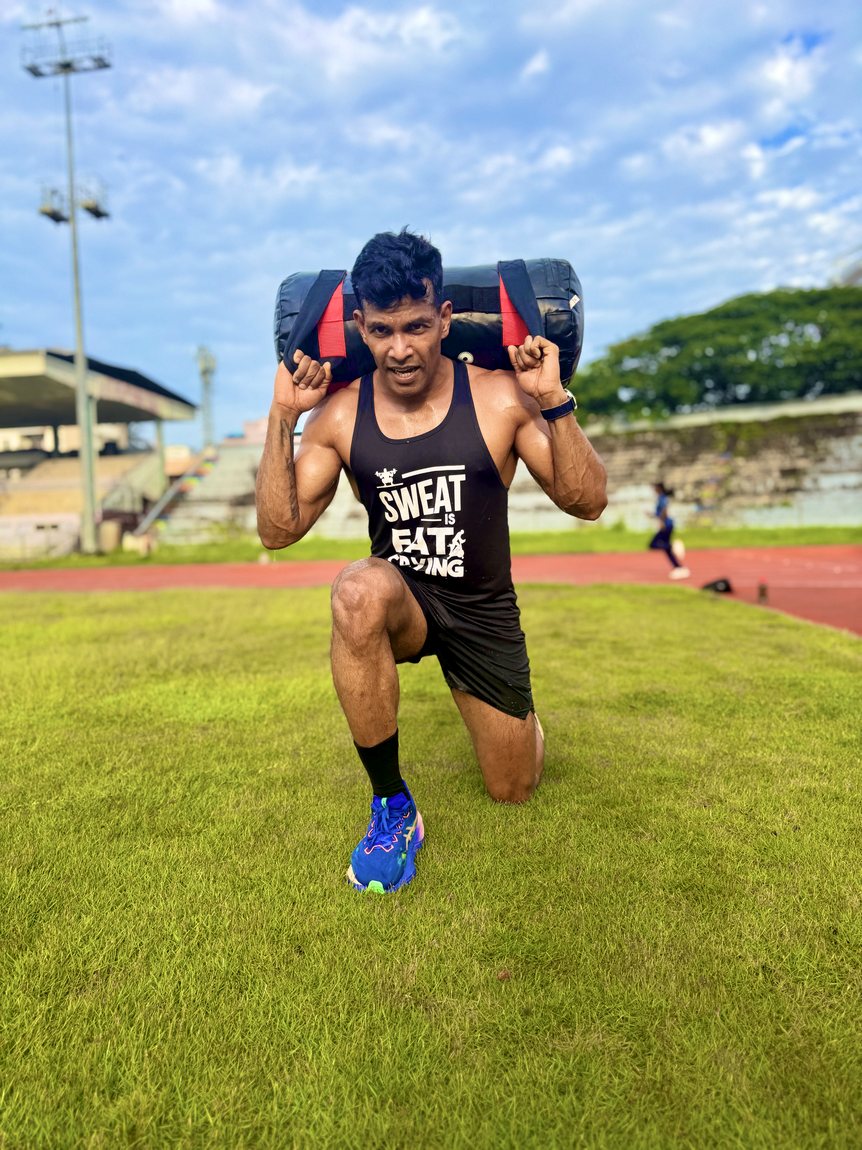Coach Joby sandbag training on the track